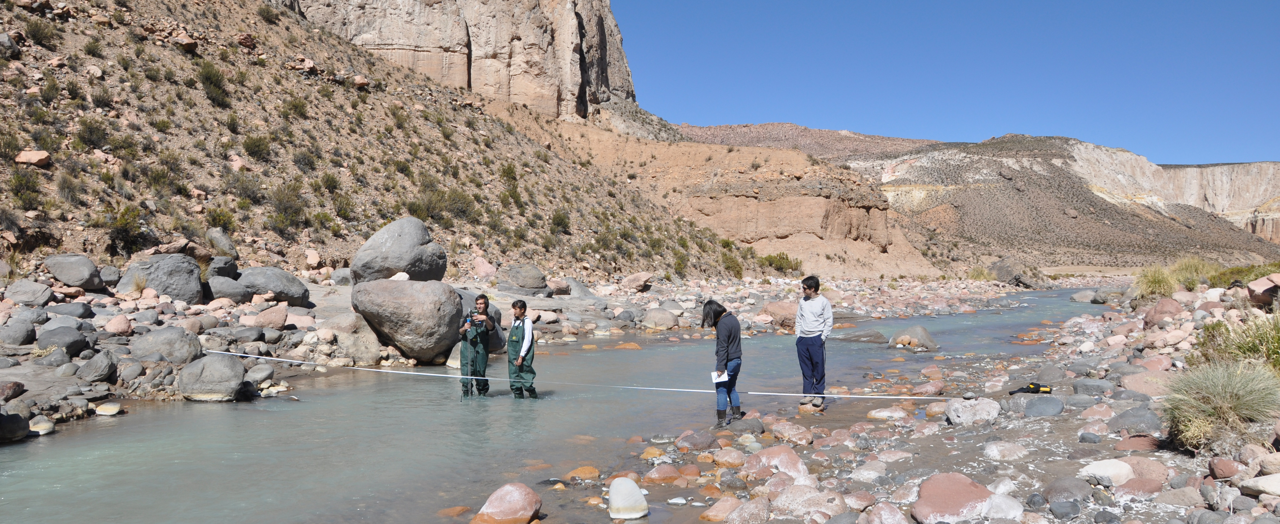Students from Engineers for a Sustainable World check the water in the Lluta River Valley.